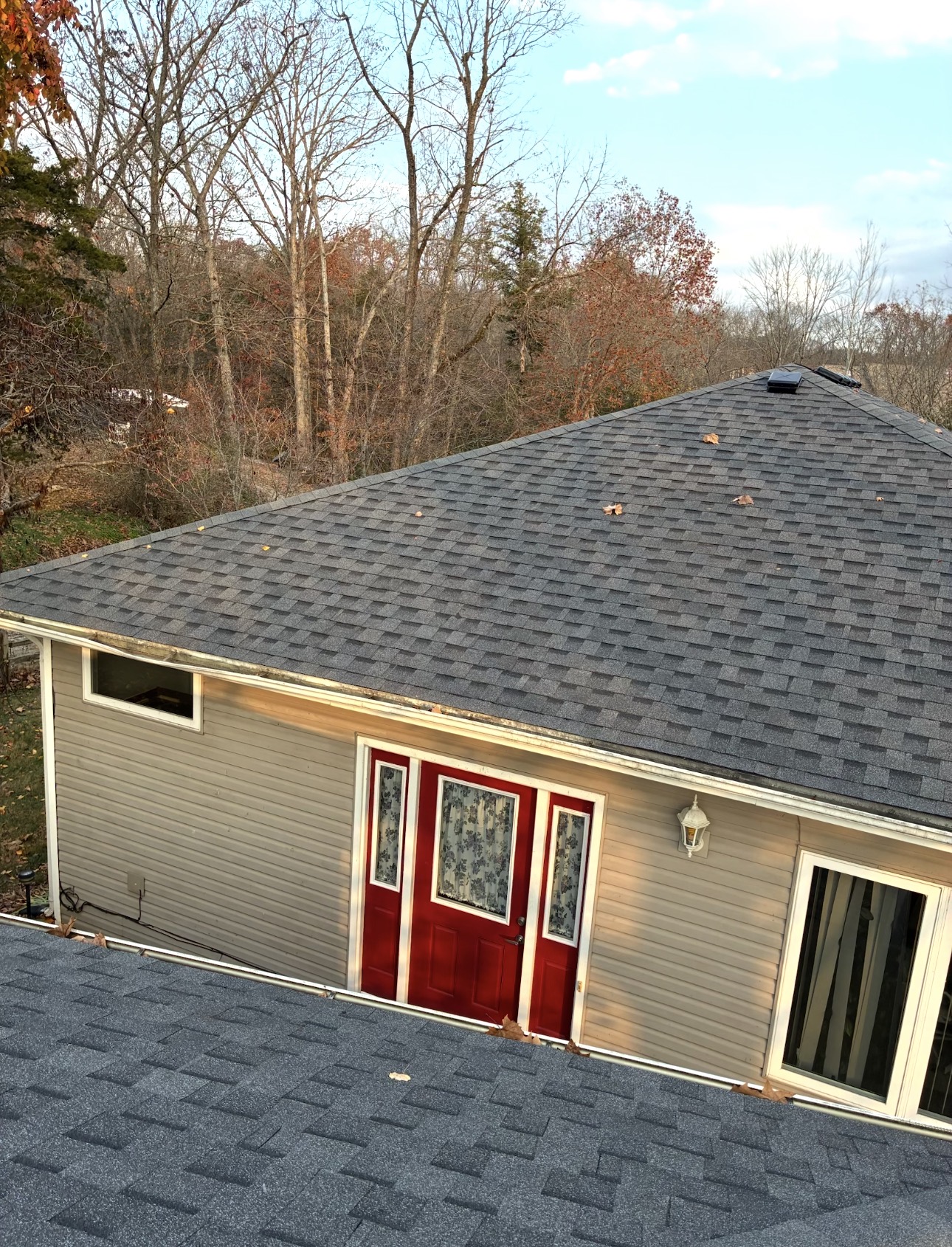 Completed gray architectural shingle roof replacement on a southwest Missouri home