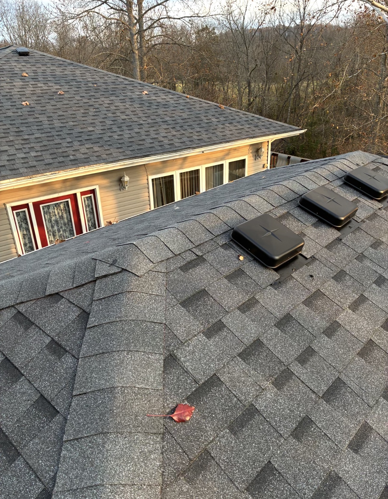 New gray shingles with upgraded black ridge vents installed by Power Plus Roofing