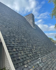Dark architectural shingle roof with stone chimney in Ozark, MO