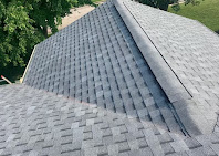 Tight close-up of a freshly installed asphalt shingle roof ridge